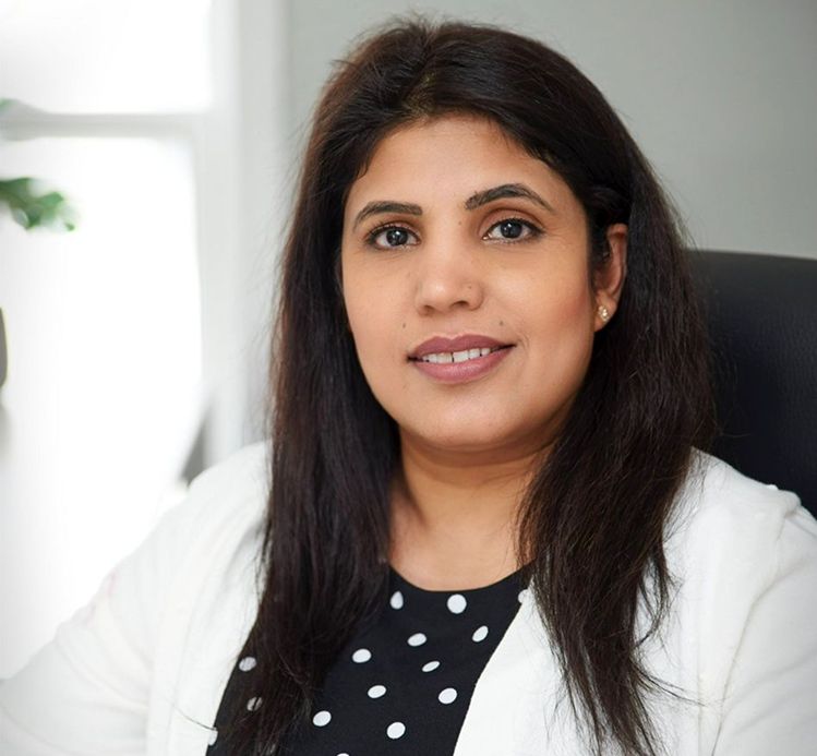 John Sharper, CEO of Glovia, sitting at a table.