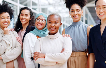 Diverse group of professionals smiling and standing together.